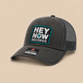 HEY NOW Square Logo Trucker Hat FRONT